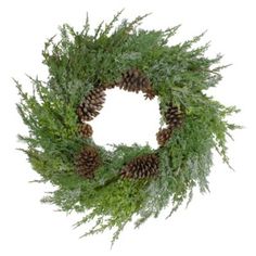 a green wreath with pine cones and greenery