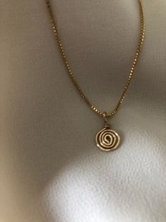 A minimal, 14kt gold filled dainty box chain necklace with a hand sculpted/ hammered mini spiral pendant that can be worn on its own or layered. Spiritually the spiral represents a connectivity with the divine, spiraling from the outer ego (the outside world) into the inner soul (cosmic awareness and enlightenment). The spiral represents evolution and growth of the spirit. It is a symbol of change and development. Pendant is hand sculpted and hammered out of 14kt gold filled wire. Each piece will be slightly different and unique. Pendant is removable and chain can be worn on its own. Perfect for people with allergies to costume jewellery as this will NOT irritate your skin.  ☛ Cleaning - simply use a little dish soap and luke-warm water and rub gently between your fingers. Dry well with a Symbol Of Change, Growth And Evolution, Spiral Pendant, Spiral Necklace, Tiny Charm, Box Chain Necklace, Wire Jewellery, Dainty Gold Necklace, Jewellery Brand