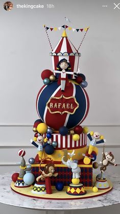 a multi - tiered cake with clowns and circus characters on it's sides