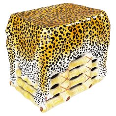 an animal print table cover with four sections stacked on top of each other, all in yellow and black