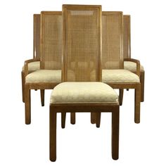 set of four chairs with cane back and seat cushions