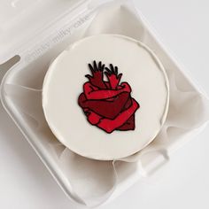 a white plate with a red heart on it