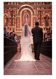 the bride and groom are walking down the aisle