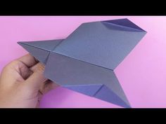 someone is holding an origami bird