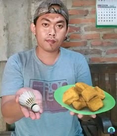 a man holding a plate with food on it