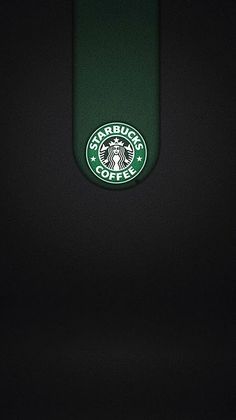 the starbucks logo is seen in this black and green photo taken at night with only one light on