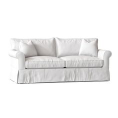 a white couch with two pillows on it's back and the seat upholstered