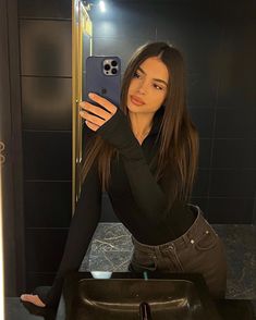 a woman taking a selfie in the bathroom