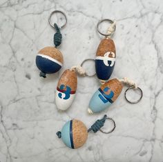 four acorns with blue and white designs are sitting on a marble counter top