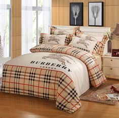 a bed room with a plaid comforter and pillows