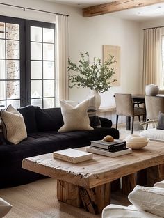 a living room filled with furniture and a wooden table