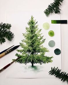 a drawing of a green christmas tree surrounded by greenery and paintbrushes on white paper