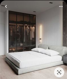 a white bed sitting next to a walk in closet