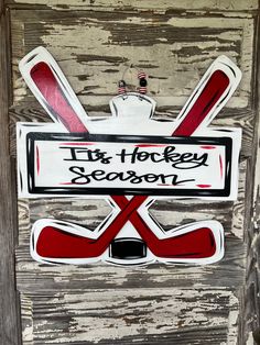 an old door with stickers on it that says its hockey season and crossed sticks