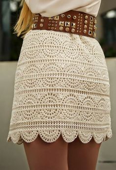 the back of a woman's skirt with crochet and gold hardwares