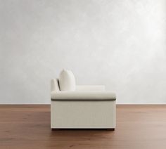 a white couch sitting on top of a wooden floor