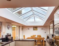 an open kitchen and dining area with skylights