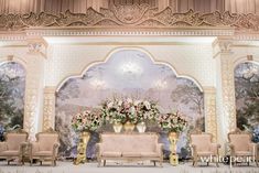 an elaborately decorated stage with floral arrangements