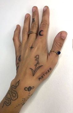 a woman's hand with tattoos on it and the word mother written in cursive writing