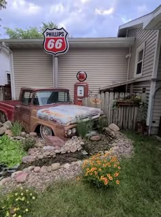 an old car is parked in front of a gas station with a sign that says phillips's 66