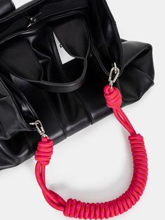 a handbag with a red rope attached to it