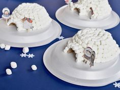 there are three cakes made to look like sheeps and snowflakes on the table