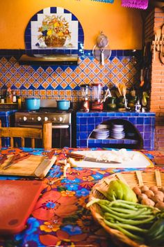 a colorful kitchen with blue and yellow tiles