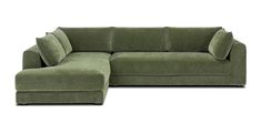 a green sectional couch with pillows on it's back and the seat folded out