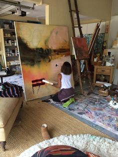 a child is painting in an art studio