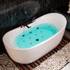 a white bath tub sitting on top of a wooden floor