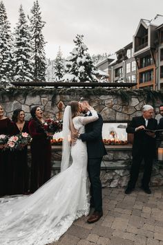 a bride and groom kissing in front of their guests