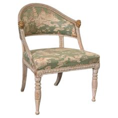 an antique chair with floral upholstered fabric and gold trimming on the armrests