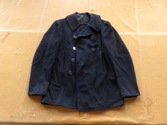 Vintage 1940s US Navy wool peacoat, corduroy lined pockets and chin strap closure. In fair condition, general wear including to button holes, some missing buttons, some small holes on shoulder and sleeve, paint mark. No size marked, fits Small. Measurements, in inches with garment laid flat: 21.5 armpit to armpit 33 down front from collar to hem 20 shoulder to shoulder 27 down sleeve from shoulder to cuff 32 down back from collar to hem Please ask any questions before purchasing, especially conc Navy Peacoat, Wool Overcoat, Button Holes, Wool Peacoat, Blue Wool, Us Navy, Shoulder To Shoulder, Bathing Beauties, Gender Neutral