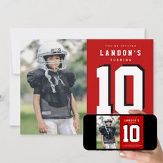 a hand holding up a card with an image of a football player and the number 10 on it