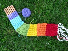 yarn and knitting needles laid out on the grass