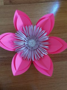 an origami flower on a wooden table