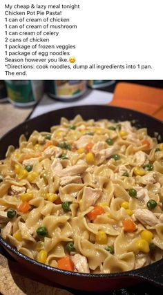 a skillet filled with pasta and vegetables on top of a table