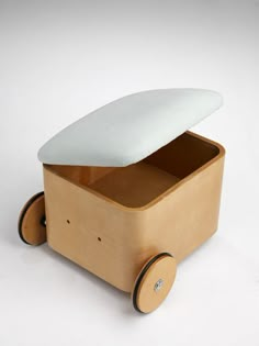 a wooden toy car with a surfboard on it's top and two wheels