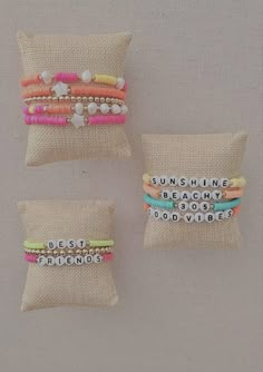 three different bracelets sitting on top of each other in front of a burlock pillow