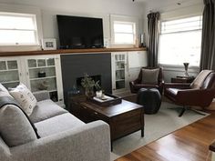 a living room filled with furniture and a flat screen tv mounted on the wall above a fireplace