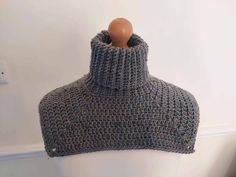 a mannequin wearing a gray knitted cowl