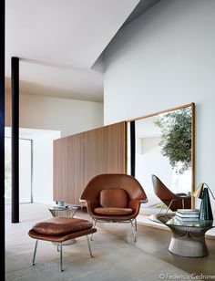 the cover of domodeco magazine with an egg chair, ottoman and coffee table