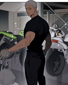 a man standing next to a motorcycle in a garage