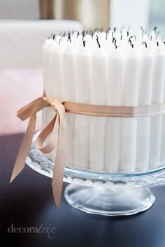 a white cake with candles tied to it