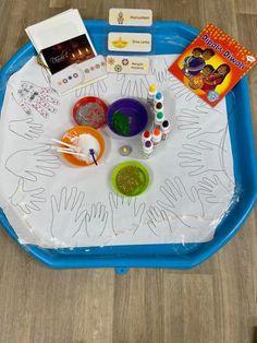 a blue tray with craft supplies on it and a book sitting on top of it