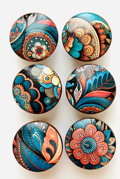 six colorful painted eggs sitting on top of each other