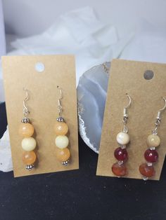 Beautiful handmade earring set of 2 gift one and keep one. These are made with real orange facited turmaline beads and natural agate and glass beads. These have silver 925 earrings hooks Handmade Agate Round Bead Earrings, Handmade Amber Beaded Round Earrings, Handmade Amber Round Bead Earrings, Handmade Amber Earrings With Round Beads, Amber Beaded Drop Earrings For Gift, Handmade Amber Agate Earrings, Dangle Beaded Earrings With Gemstone Beads As Gift, Gemstone Beads Dangle Earrings Gift, Handmade Adjustable Amber Earrings