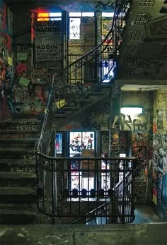 a stairwell with graffiti on the walls and stairs