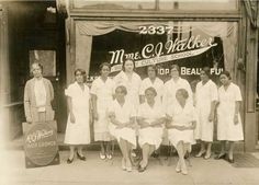 black and white photograph of nurses in front of a medical office with an old sign