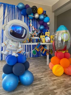 an astronaut balloon decoration with balloons and streamers